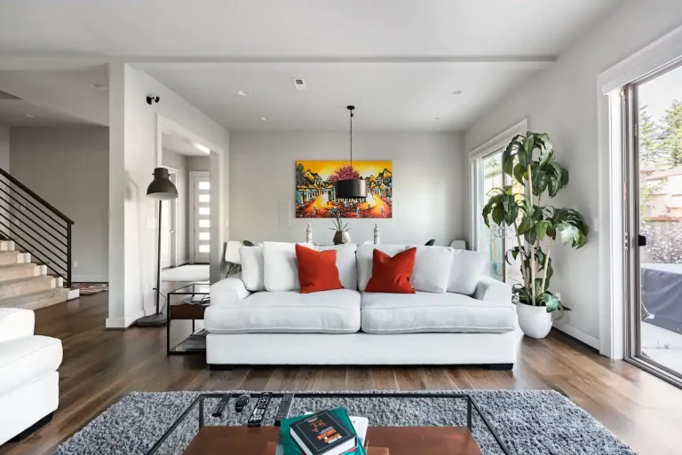 A calm, modern living room with an airy feel and natural light from the patio